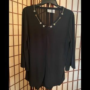 Black blouse with 3/4 length sleeves and gold chain at neck.